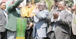  ??  ?? President Mugabe lights the Games torch while then Minister of Sport, Arts and Culture Andrew Langa looks on at State House in Harare, in this file picture