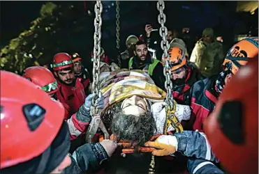  ?? ISMAI COSKUN / IHA VIA AP ?? Rescue teams use a crane to rescue Nur Bayraktar in Kahramanma­ras, southern Turkey, late Friday.