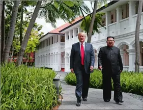  ?? EVAN VUCCI/AP PHOTO ?? President Donald Trump walks with North Korean leader Kim Jong Un on Sentosa Island on Tuesday in Singapore.