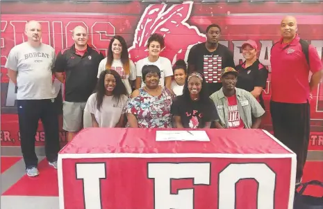  ?? (Photo by Scott Herpst) ?? LFO graduate Jerriale Jackson (seated, second from right) signed her letter of intent on Thursday, June 7 to play basketball for Georgia Northweste­rn Technical College. Also on hand for the ceremony was (front row, from left) Jerrian Jackson, Anita Rucker and Jerry Jackson. On the back row was GNTC head coach David Stephenson, LFO assistant coaches Matt Culbreth and Krista Davis, Athena Coats, Zaryus Coats, Alex Stallion, LFO assistant coach Keri Miller and LFO head coach Dewayne Watkins.