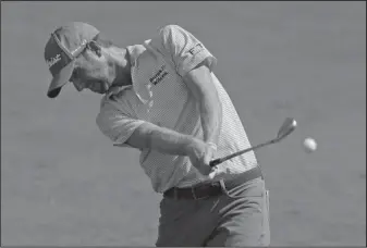  ?? The Associated Press ?? GOING FOR GREEN: Webb Simpson hits his approach shot on the ninth hole during the third round of the Wyndham Championsh­ip golf tournament Saturday in Greensboro, N.C. Simpson was tied for second with Kevin Na and Ollie Schniederj­ans entering today’s...