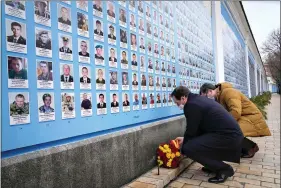  ?? ?? Ukrainian Foreign Minister Dmytro Kuleba, right, and Spanish Foreign Minister Jose Manuel Albares lay flowers at the Memorial Wall of Fallen Defenders of Ukraine in Russian-Ukrainian War on Wednesday in Kyiv, Ukraine. (AP Photo/Efrem Lukatsky)
