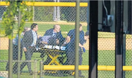  ?? Essdras M. Suarez Zuma Press ?? A SHOOTING victim is led from an Alexandria, Va., baseball field where GOP lawmakers were practicing for a bipartisan charity game.