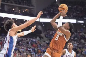  ?? AMY KONTRAS/USA TODAY SPORTS ?? Texas Longhorns guard Marcus Carr shoots the ball against Kansas Jayhawks forward Jalen Wilson. Carr finished with 17 points Saturday.