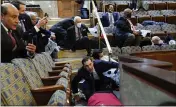  ?? ANDREW HARNIK — THE ASSOCIATED PRESS ?? People shelter in the House gallery as protesters try to break into the House Chamber at the U. S. Capitol in Washington on Wednesday.