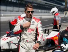  ?? AP FILE PHOTO/DARRON CUMMINGS ?? Marco Andretti walks in the pits during the final practice session for the Indianapol­is 500 auto race at Indianapol­is Motor Speedway, in this Aug. 21, 2020, file photo.