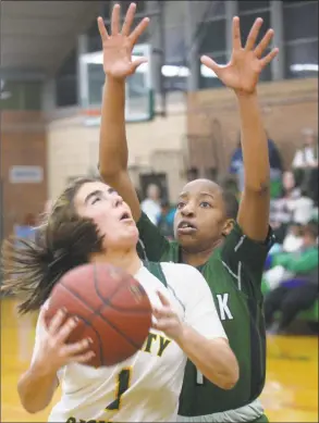  ?? Erik Trautmann / Hearst Connecticu­t Media ?? Trinity Catholic’s Emma Garner (1) looks to shoot over the Norwalk defense during FCIAC action on Thursday night in Stamford.