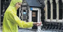  ?? PHOTO: ALISON JACOBS ?? Frozen H2O . . . Odin Jacobs (14) handles some of the heavy hail which fell at the University of Otago in Dunedin yesterday.