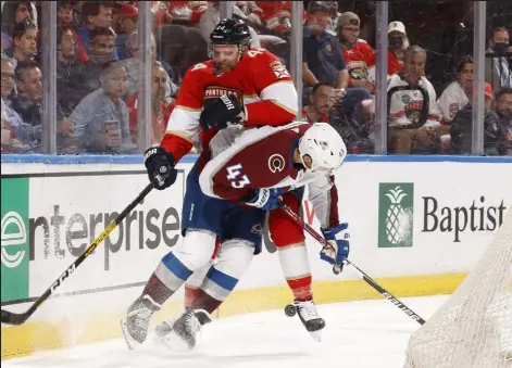  ?? JOEL AUERBACH
Getty Images ?? The Avalanche’s Darren Helm, front, makes contact with the Panthers’ Kevin Connauton behind the net during the second period Thursday in Sunrise, Fla.