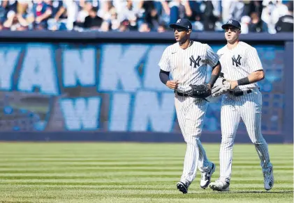  ?? JESSIE ALCHEH/AP ?? Yankees center fielder Aaron Hicks and left fielder Joey Gallo run in for handshakes after a win over the Guardians on April 24 in New York.