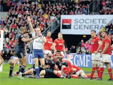  ??  ?? Referee Wayne Barnes awards France a try during the game against Wales in Paris on Saturday