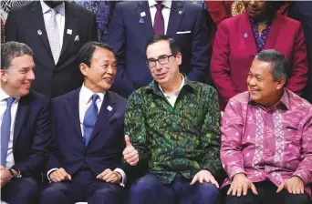  ?? Bloomberg ?? Steve Mnuchin (second from right) with Nicolas Dujovne, Argentina’s economy minister (left), Taro Aso, Japan’s finance minister (second from left), and Perry Warjiyo, governor of the Bank Indonesia at the IMF and World Bank Group annual meetings in Nusa Dua, Indonesia, yesterday.