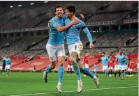  ??  ?? Defensive duo…the partnershi­p of Ruben Dias and Stones has been key for City