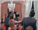  ??  ?? President Donald Trump points a finger as a White House aide reaches for a microphone being used by CNN reporter Jim Acosta.