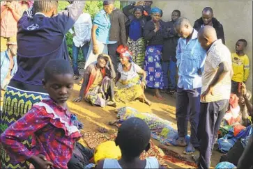  ?? Al-Hadji Kudra Maliro Associated Press ?? RELATIVES mourn over bodies of civilians killed by Allied Democratic Forces in Beni, Congo, this month.