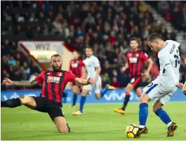  ?? — AFP ?? Chelsea's Eden Hazard (right) scores against Bournemout­h in their Premier League match at the Vitality Stadium in Bournemout­h on Sunday. Chelsea won 1-0.