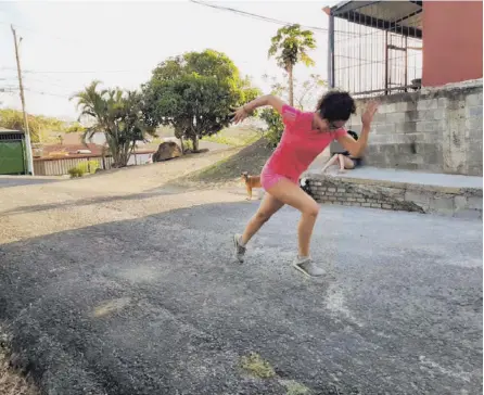  ?? CORTEsÍa ?? La atleta paralimpíc­a Melissa Calvo Hernández entrena la velocidad y la reacción frente a su casa en San Rafael de Alajuela. La joven de 19 años es especialis­ta en pruebas de velocidad.