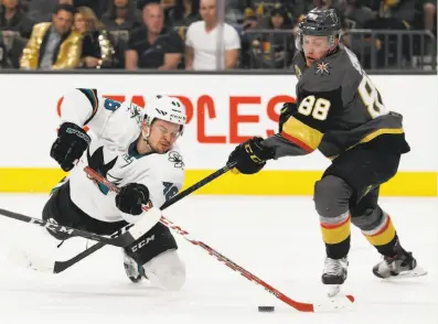  ?? John Locher / Associated Press ?? Sharks center Tomas Hertl vies for the puck with Golden Knights defenseman Nate Schmidt(88) ng the second period of Vegas’ 3-2 victory Saturday. The win clinches the Pacific Division title for the Golden Knights, who are in their inaugural season. The...