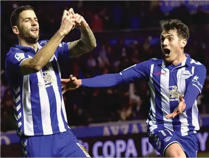  ??  ?? In this Wednesday, 8 February, 2017 file photo, Alaves’ Edgar Mendez, left, celebrates his goal with teammate Iabi Gomez, after scoring against Celta, during the Spanish Copa del Rey semifinal, second leg match between Alaves and Celta.