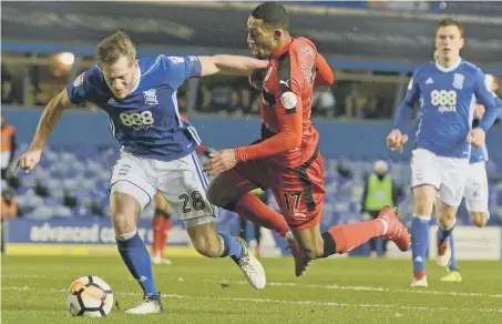  ??  ?? Birmingham skipper Michael Morrison (left) defends against Huddersfie­ld’s Rajiv van la Parra in the FA Cup earlier this season.