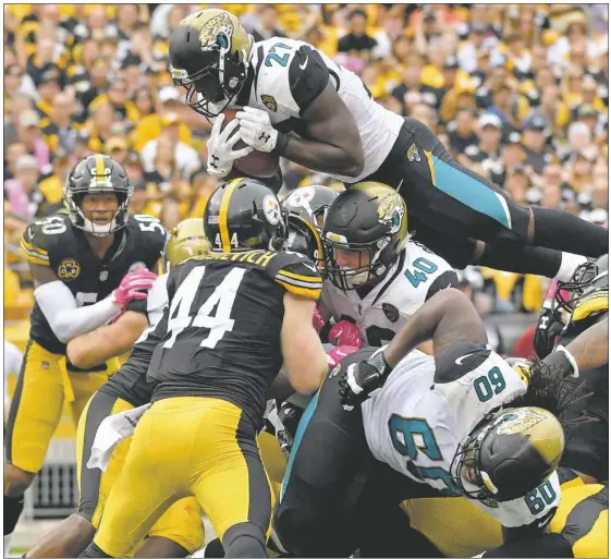  ?? Matt Freed/Post-Gazette ?? Jaguars running back Leonard Fournette leaps for one of his two touchdowns Sunday against the Steelers at Heinz Field.