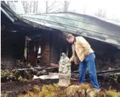  ?? ASSOCIATED PRESS FILE PHOTO ?? Senior Pastor Kim McCroskey inspects a statue outside the remains of the family life center at Roaring Fork Baptist Church in Gatlinburg on Dec. 6, 2016. The church and center burned down in fires a week earlier.
