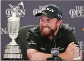  ?? PETER MORRISON/AP PHOTO ?? Ireland’s Shane Lowry smiles as he sits next to the Claret Jug trophy while he attends a press conference after he won the British Open Golf Championsh­ips on Sunday at Royal Portrush.