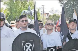  ?? [ALAN GOFFINSKI] ?? James Alex Fields Jr., second from left, holds a black shield in Charlottes­ville, Va., during a white nationalis­t rally on Saturday. Fields was later charged with second-degree murder and other counts after authoritie­s say he plowed a car into a crowd...