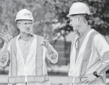  ?? Mark Mulligan / Staff photograph­er ?? The FCC’s Brendan Carr, left, talks with Mike Kavanagh of Crown Castle. Carr has warned about China leading with 5G.