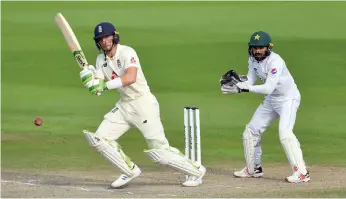  ?? Getty ?? Chris Woakes, top, celebrates with Dom Bess after clinching a tense three-wicket win in the Manchester Test against Pakistan, after getting great support from Jos Buttler, above