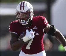  ?? AP FILE ?? HANDLING THE BALL: UMass running back Ellis Merriweath­er runs against Boston College on Sept 11.