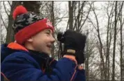  ?? KEVIN MARTIN — THE MORNING JOURNAL ?? Isaik Schoch, 13, of Ashland attempts to identify birds on Jones Road in Huntington Township on Dec. 29as part of the Christmas Bird Count.