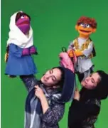  ??  ?? Afghan puppeteers Seema Sultani (right) holds new Sesame Street Muppet 'Zeerak' as she performs with colleague Mansoora Shirzad, holding Muppet 'Zari', during a recording at a television studio in Kabul.