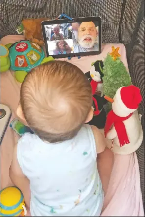  ?? (Courtesy Photo/Julie Bufkin) ?? Seven-month-old Calvin Bufkin interacts with his grandmothe­r, Debbie Cameron, in Chandler, Ariz., on a FaceTime call from his crib in Tempe, Ariz. The Camerons are among the grandparen­ts all over the country going through a piercing distance from their loved ones for their own protection during the coronaviru­s crisis.