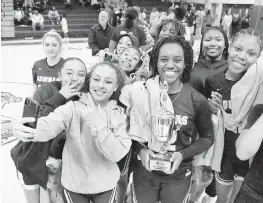  ?? ANDREW ULOZA FOR THE MIAMI HERALD ?? St. Thomas Aquinas players take a selfie after they won the BCAA Big 8 girls’ basketball championsh­ip game against Blanche Ely on Saturday at South Plantation High.