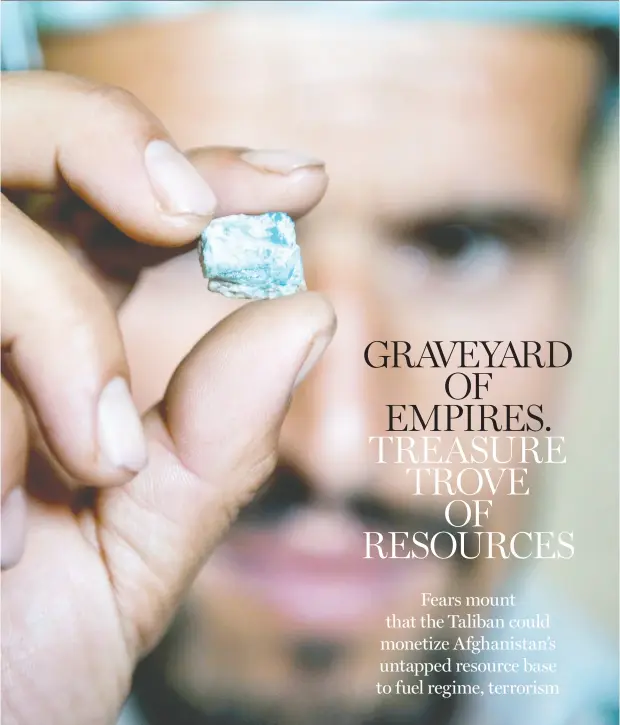  ?? MAJID SAEEDI / GETTY IMAGES ?? An Afghan miner examines an emerald from a makeshift mine in the Panjshir Valley. Afghanista­n is sitting on significan­t deposits of oil, gas, copper, iron, gold and coal, rare earth minerals, as well as a range of precious gems such as emeralds and rubies.