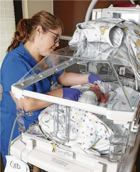  ?? Photos by Melissa Phillip / Staff photograph­er ?? Nurse Megan Matula cares for Grayson in the neonatal intensive care unit at The Woman’s Hospital, which partners with the March of Dimes to support families with premature babies.