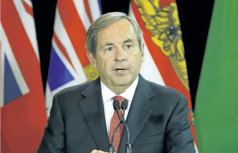  ?? LARRY WONG/POSTMEDIA NETWORK ?? David MacNaughto­n, Canada’s Ambassador to the United States, speaks with news media before meeting with Canada’s provincial Premiers and National Indigenous Organizati­on Leaders in Edmonton on Tuesday. Trade with the U.S. will be a prominent topic at...