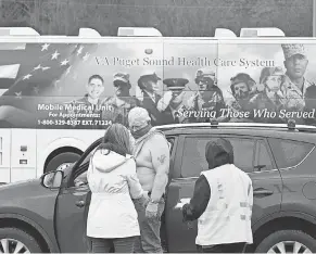  ?? TED S. WARREN/ AP ?? Veteran Richard Linn receives a COVID- 19 vaccine last week at a mobile vaccinatio­n clinic in Shelton, Washington.