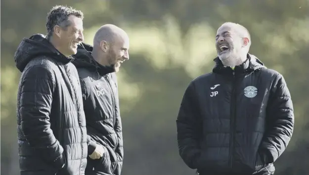  ?? ?? Hibs manager Jack Ross shares a laugh with first team coach David Gray and assistant manager John Potter