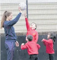  ??  ?? Helping hand Hamilton’s netball star Bethan Goodwin gives youngsters some tips at a recent school sports festival