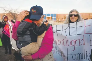  ?? Joe Amon, THE DENVER POST ?? In this file photo from January 2018, Anibal Jurado, 2, is hugged by his grandfathe­r Jesus Jurado, outside the for-profit detention facility GEO where their father and son, Eliseo Jurado, is detained. Eliseo Jurado was picked up by six ICE agents in Westminste­r, held for several weeks and released on bond. He is the husband of Ingrid Encalada Latorre who is living in sanctuary.