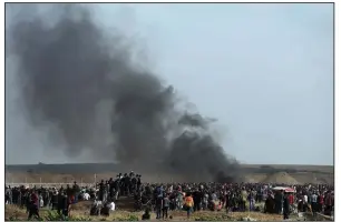  ?? AP/KHALIL HAMRA ?? Smoke from burning tires rises over the site at the Gaza Strip border with Israel where Palestinia­ns on Friday held another mass protest.