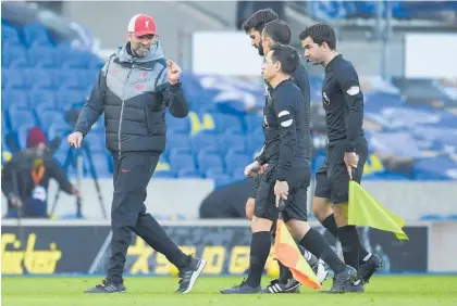  ?? Photo / AP ?? Jurgen Klopp shares his thoughts with the officials after Brighton’s stoppage-time penalty.