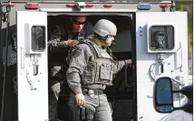  ?? STEVE GONZALES / HOUSTON CHRONICLE ?? Emergency personnel respond to an active shooter in front of Santa Fe High School on Friday.