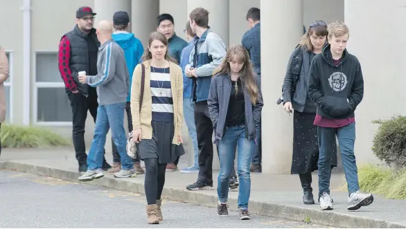  ?? RICHARD LAM ?? Friends of Letisha Reimer leave South Abbotsford Church after a memorial service was held Thursday for the teen killed by an apparent stranger while attending high school.