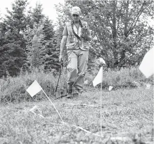  ?? TIM KROCHAK • THE CHRONICLE HERALD ?? Archaeolog­ist Jonathan Fowler uses an electro-magnetomet­er near the site of the former Shubenacad­ie residentia­l school on July 12.