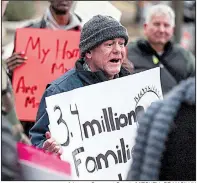  ?? Arkansas Democrat-Gazette/MITCHELL PE MASILUN ?? Neil Sealy, an advocate with Arkansas Community Organizati­ons, leads a chant Friday in downtown Little Rock during a protest over the federal government shutdown. Sealy says unfair landlord-tenant laws and inadequate­ly funded code enforcemen­t agencies have led to “deplorable conditions” for some renters.