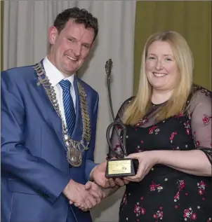  ??  ?? Presentati­on of trophy for the Best Establishe­d Business by Cllr Colm Markey Cathaoirle­ach Louth County Council to Nikki Reddy of Celtic Adventures.