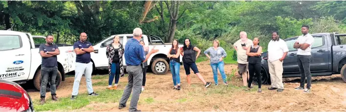  ?? ?? The group of Ranger drivers and their co-pilots getting expert 4x4 advice from one of Ford SA’s off-road instructor­s